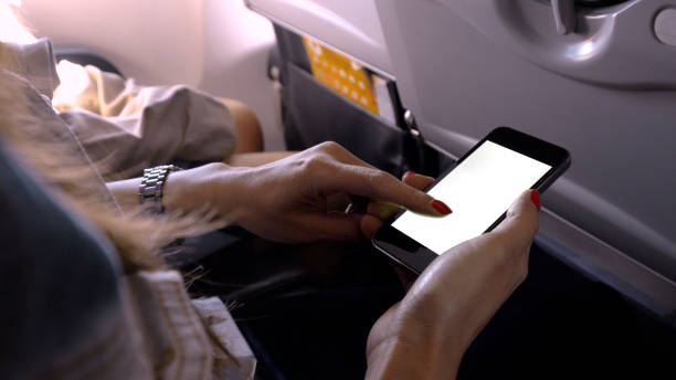 istock touching and slide mobile phone screen on airplane or aircraft 930900054