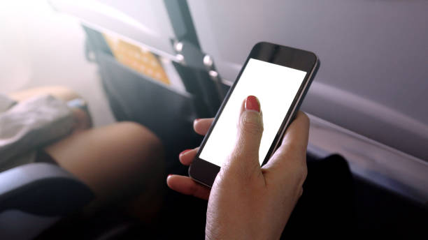 istock touching and slide mobile phone screen on airplane or aircraft 930900062