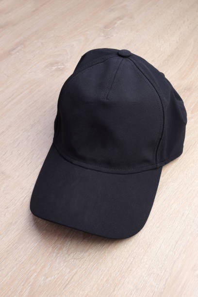 istock Black cap on wooden background 930900114