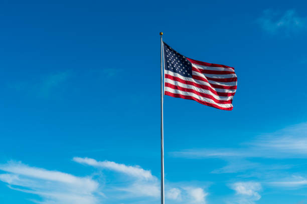 istock American Flag with interesting sky and clouds 930910666