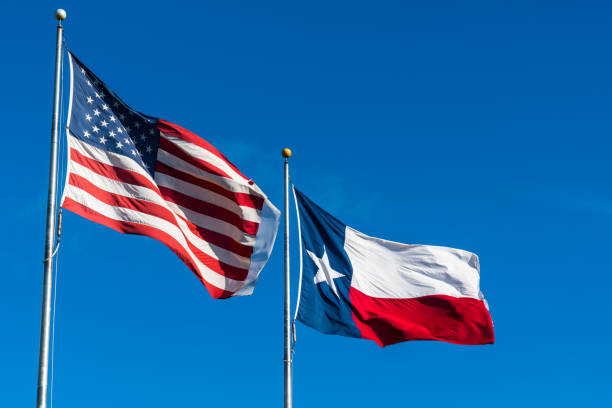 istock American Flag and Texas Flag under blue sky 930910800