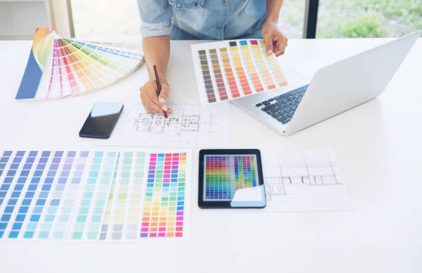 istock Creative creativity graphic designer working with graphics tablet,laptop and smart phone, colour chart at workplace on wooden desk , colour ideas style concept 930911036