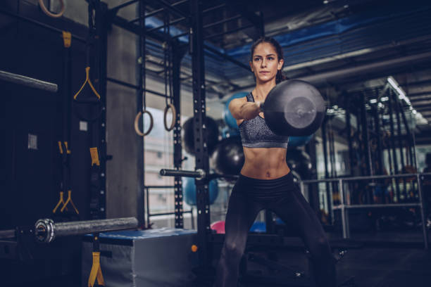 istock Young woman exercising in gym 930915838