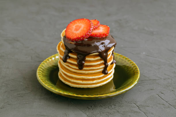 istock Pancakes with chocolate sauce and strawberries on a gray background. 930918834