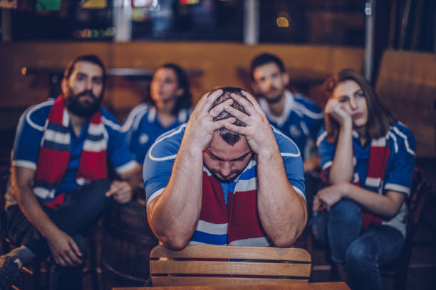 istock Friends watching football game in pub 930925620