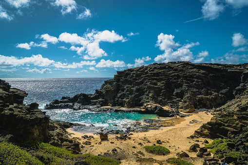 Small beach at Hawaii's Halona Blowhole surrounded by cliffs and rocks.