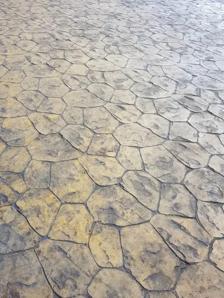 Photo of Popular stamped concrete flooring - Retro style stained grunge pedestrian walkway.