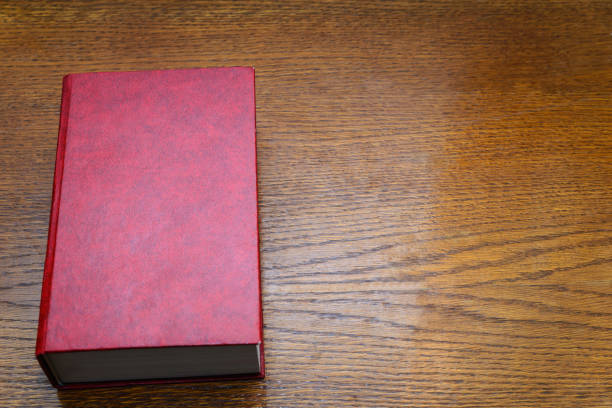 istock Red book on a wooden background 930930212