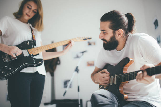 istock Couple playing guitar together 930930940