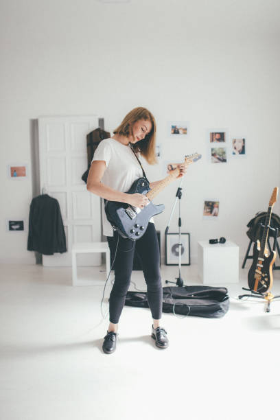 istock Beautiful woman playing guitar 930931044