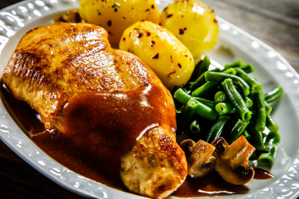 istock Roast chicken breast in sauce, boiled potatoes and vegetables 930933566