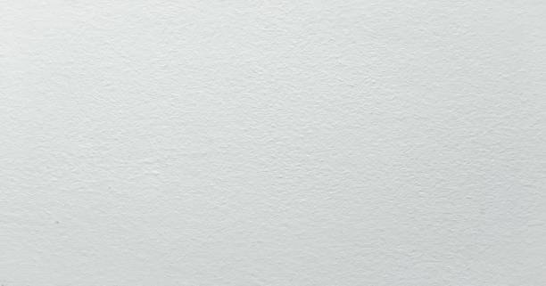 istock Grungy painted wall texture as background. Cracked concrete vintage wall background, old white painted wall. Background washed painting. 930934168