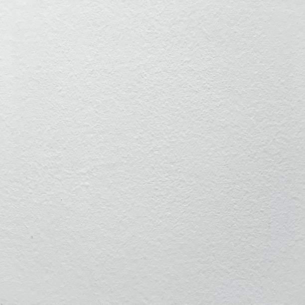 istock Grungy painted wall texture as background. Cracked concrete vintage wall background, old white painted wall. Background washed painting. 930934292