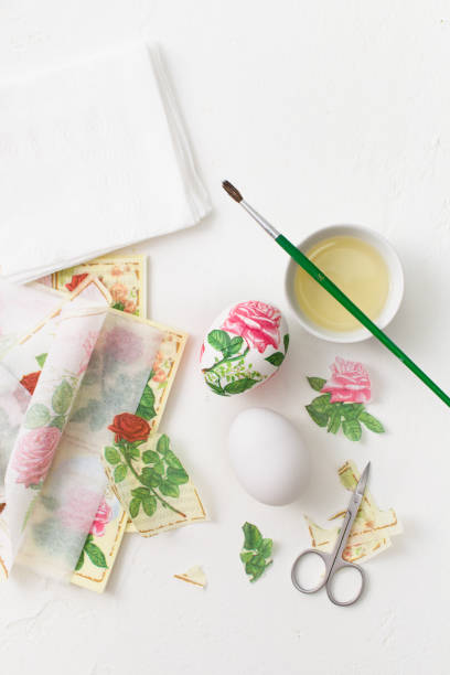 istock Decoupage on white eggs. The decoration of eggs for Easter. 930936616