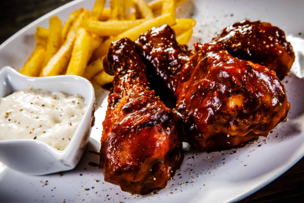 istock Fried chicken drumstics with French fries 930939878