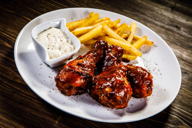 istock Fried chicken drumstics with French fries 930939992