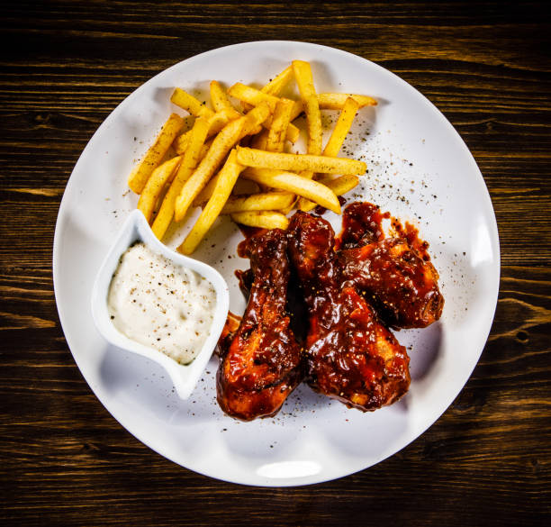 istock Fried chicken drumstics with French fries 930940446
