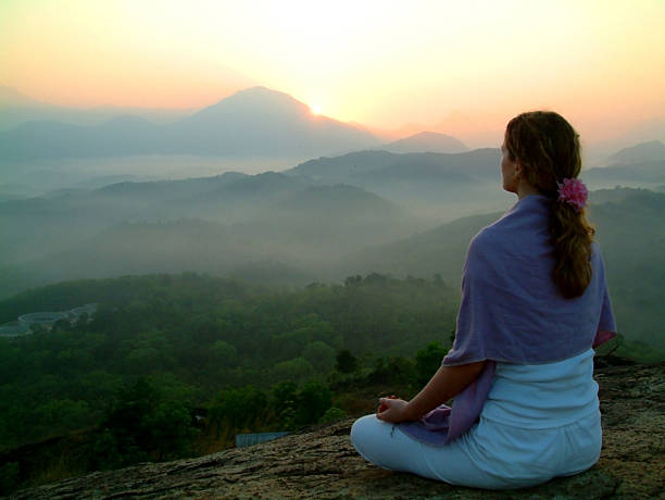 sun rising meditation stock photo