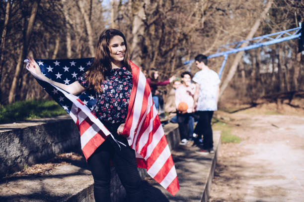 istock Female  young patriot  holding US flag 930943930