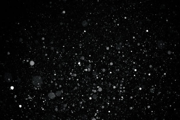 istock closeup background texture of snowflakes during a snowfall on a black background 930947678
