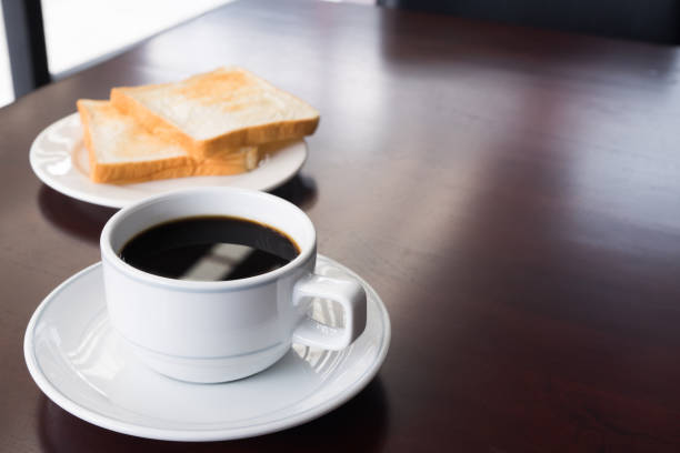 istock A cup of Coffee with bread on teble in the morning 930950178