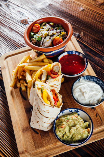 istock Chicken wrap with fried fries and salad 930961976