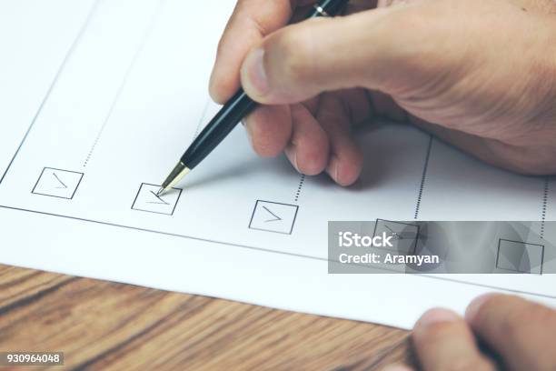 Businessman Preparing Checklist At Office Desk Stock Photo - Download Image Now - Checklist, Hand, Adult