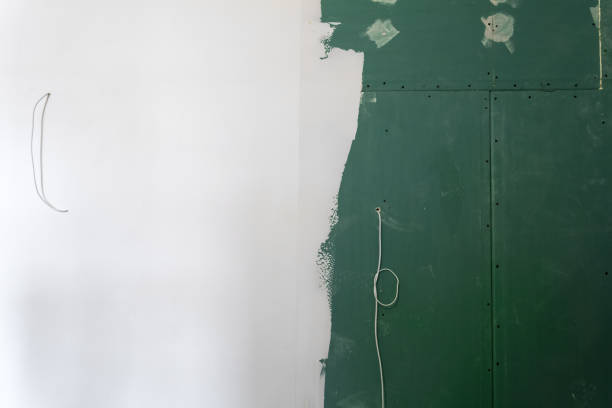 istock Plasterboard or drywall wall half painted with wires in an apartment during on the construction, remodeling, rebuilding and renovation. 930974124