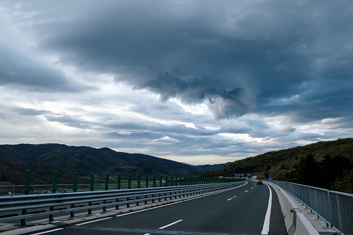 Highway and dark stormy dramatic sky in Slovenia