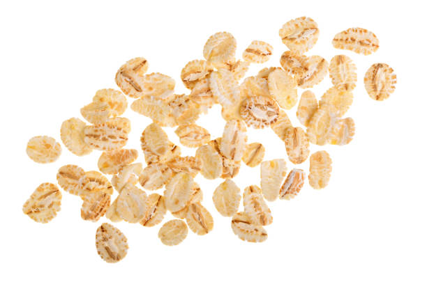 istock oat flakes isolated on white background. Top view 930985204