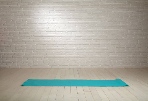 istock Empty room background wooden floor white brick wall fit mat 930988900