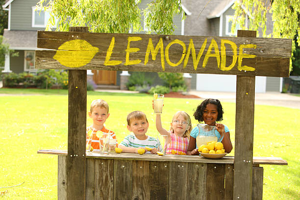 bambini con bancarella della limonata - limonata foto e immagini stock