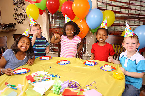 istock Smiling children eating cake at a birthday party 93099237