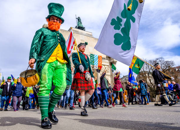 St. Patricks day - Munich Munich, Germany - March 11, 2018: People celebrating the annual national irish holiday St. Patricks day marching in the old town in munich, germany on  March 11, 2018 siegestor stock pictures, royalty-free photos & images
