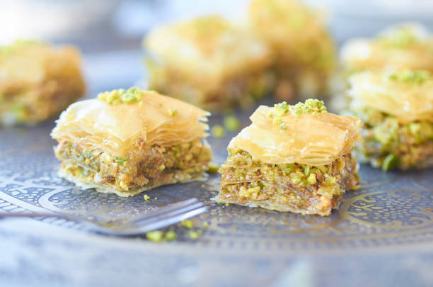 golden sweet baklava freshly baked with pistachio on tray - turkey turkish culture middle eastern culture middle east imagens e fotografias de stock