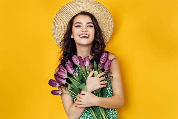 istock Lovely woman with yellow tulips bunch 931003608