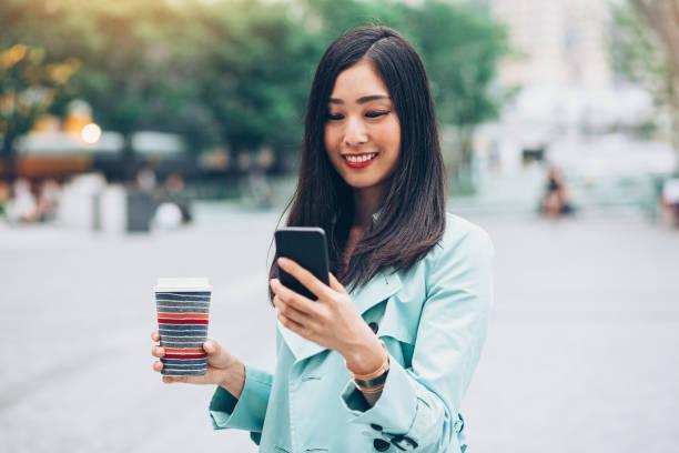 istock Beautiful girl with smart phone and coffee 931004128