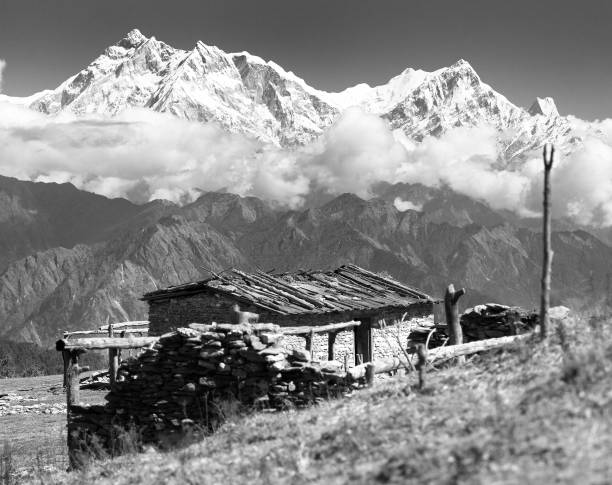 view from Jaljala pass with chalet on pastureland and mount Annapurna - Nepal, black and white view