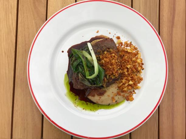 istock Well decorated meat meal seen from above. White plate with red border. 931015076
