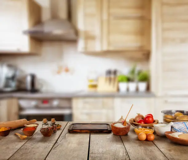 Photo of Kitchen Baking ingredients placed on wooden table, ready for cooking.