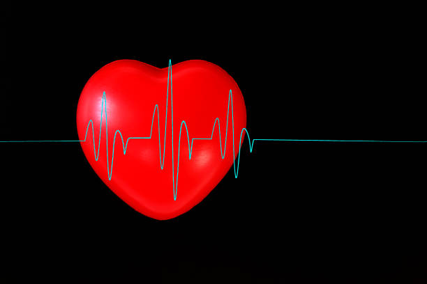 istock heart on a black background with a blue cardiogram 931022050