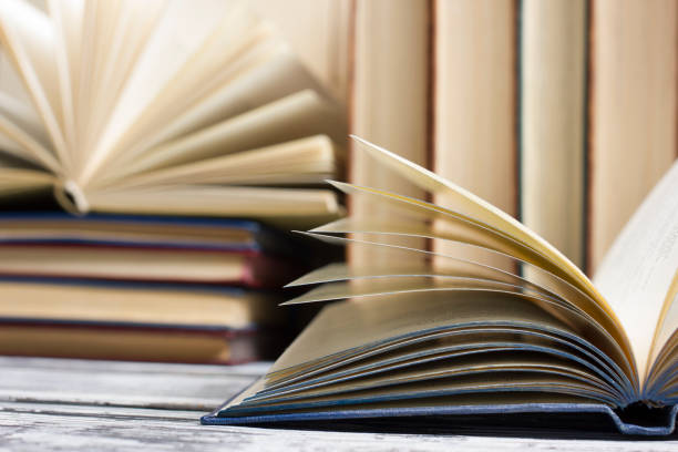 istock Open book, hardback books on wooden table. Back to school. Copy space 931022120