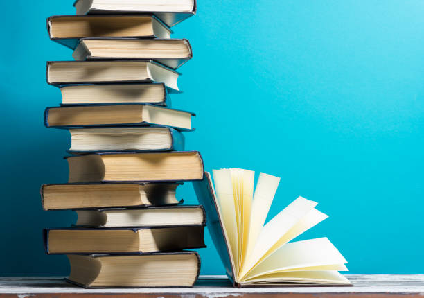 istock Open book, hardback books on wooden table. Back to school. Copy space 931024350