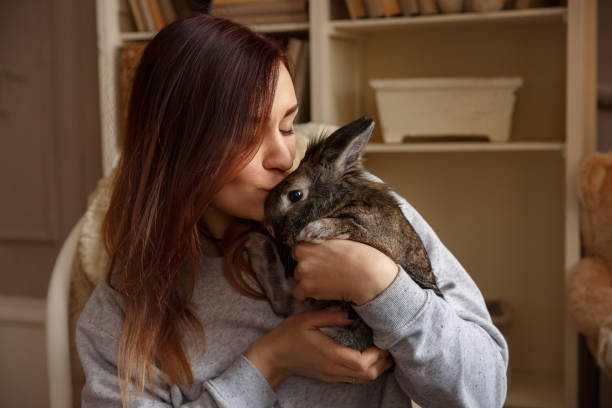 istock Happy woman kissing Easter bunny at Easter day 931024510