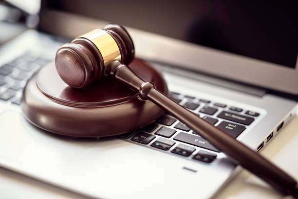 Justice gavel on laptop computer keyboard Gavel on laptop computer keyboard concept for online internet auction or legal attorney assistance lawyer hammer stock pictures, royalty-free photos & images