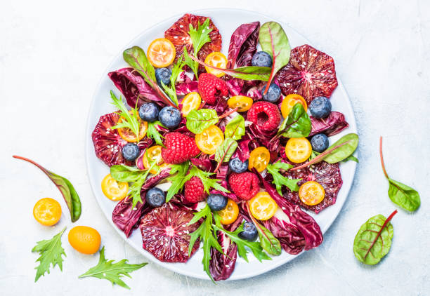 istock Vitamin salad plate greens with fruits. 931025474