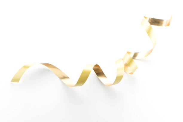 istock Golden ribbon roll isolated on white background 931040436