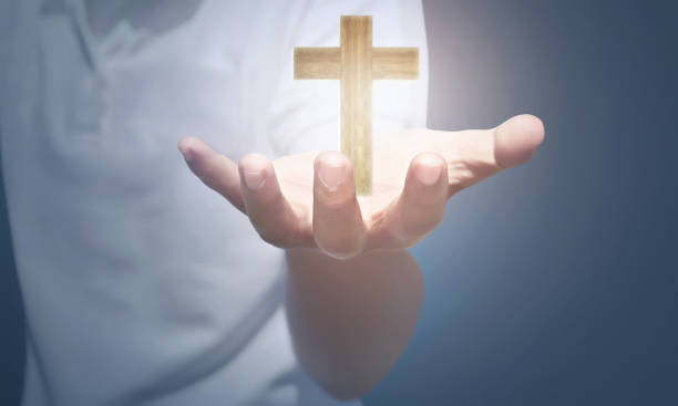 istock People hand holding wooden cross 931040632