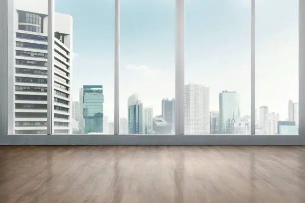 Empty office room with wooden floor with cityscape background