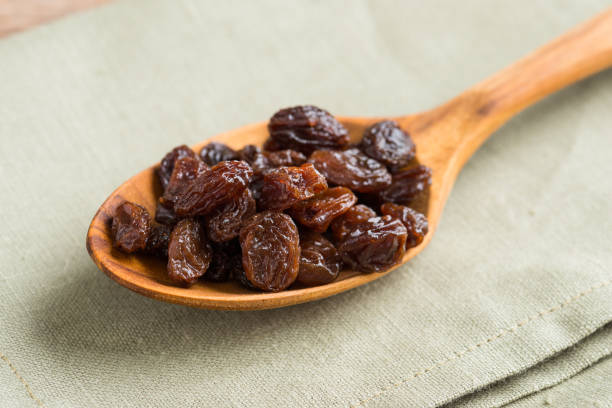 istock Raisins on a wood background. 931041562